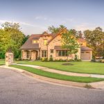 A big brown bricked house with a landscape in Stanislaus County