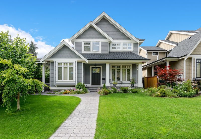 A two story grey colour house and greenery upfront.New Bridge Property Management can provide property management for a house like this